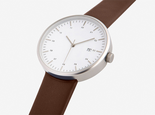 image of a watch, with a brwon strap and silver frame, placed in a white background