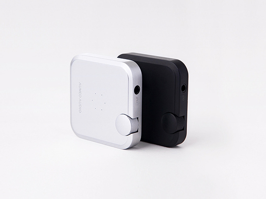 image of Portable audio adapter in white and black with side control knob and in/out ports